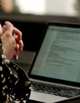 A person writing a script on their laptop