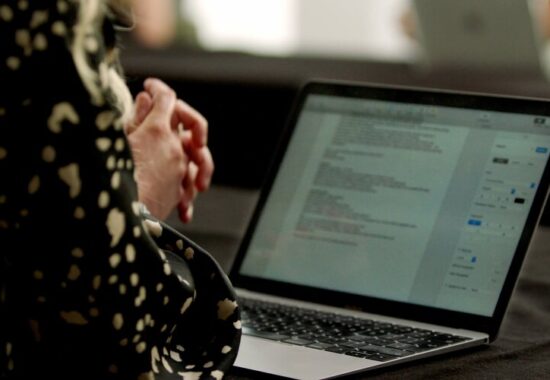 A person writing a script on their laptop