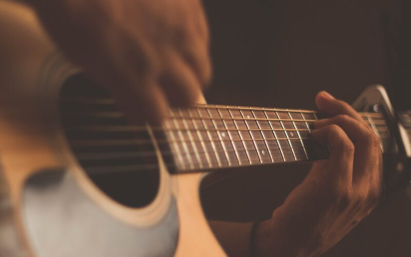 A person plays the guitar
