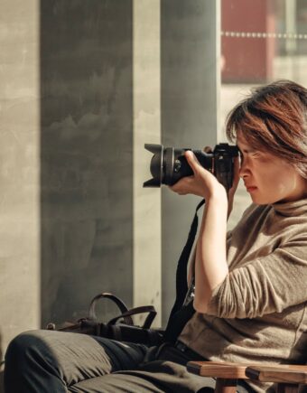 A person holds a camera up as they take a picture