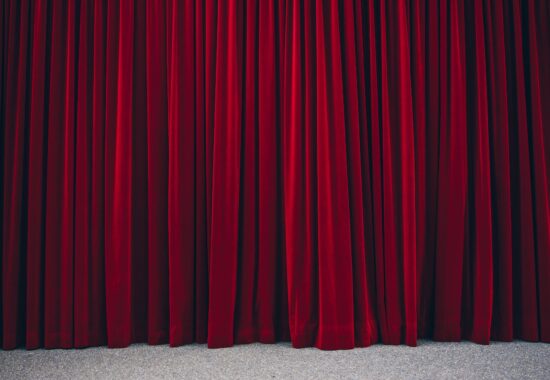 A velvet red curtain closed