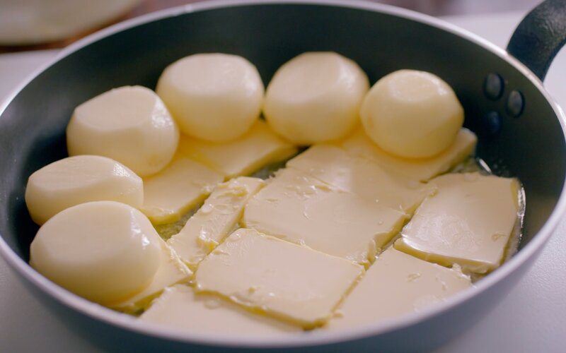Fondant potatoes layered on butter