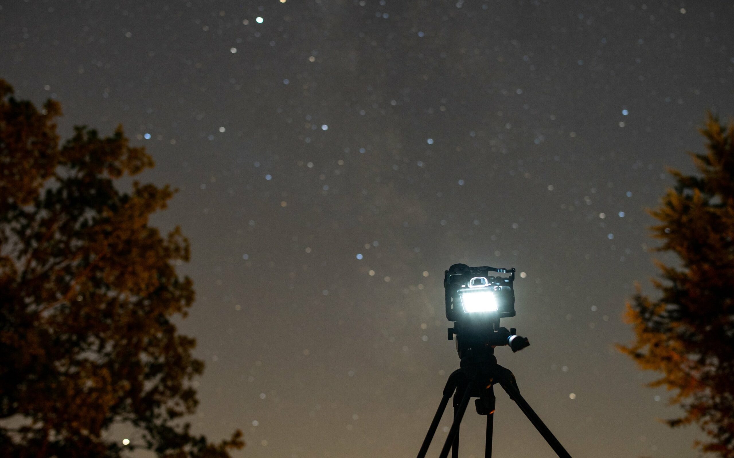 A camera set up in front of a night sky