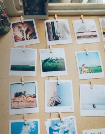 A selection of polaroids lie on a table