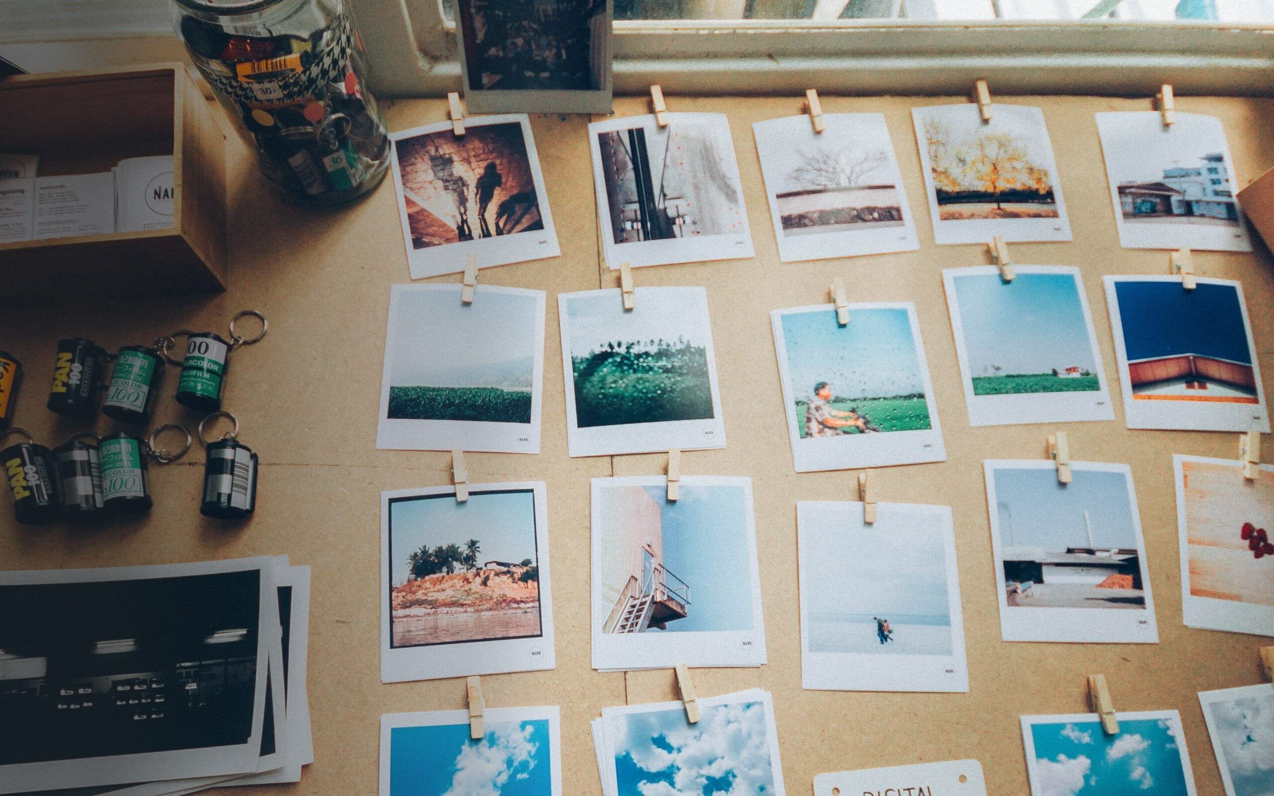 A selection of polaroids lie on a table