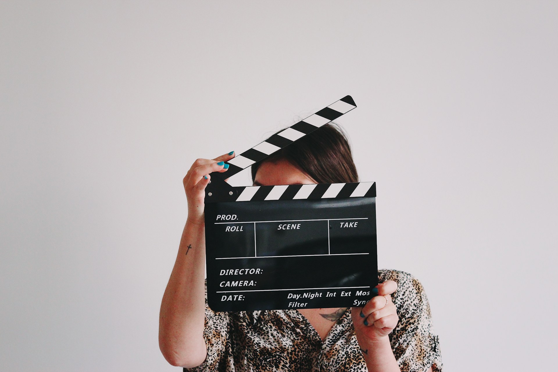 woman holding a clapper over her face