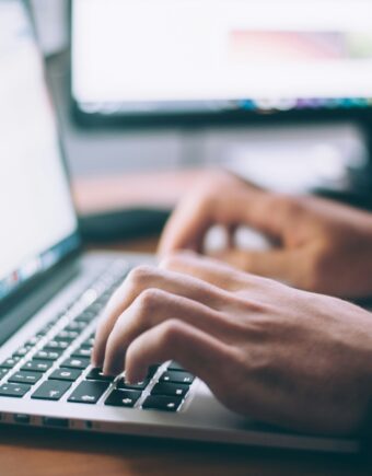 A person typing on a laptop