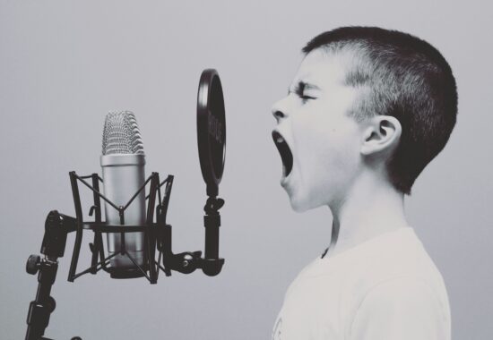An image of a child screeching into a microphone.
