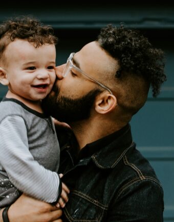 Man hugging boy