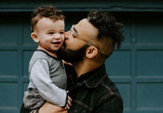 Man hugging boy