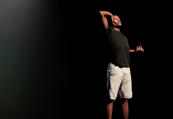 Man in black Tshirt and White shorts.