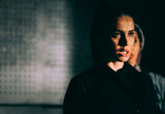 Women in black with dark hair. Looking angry and stressed